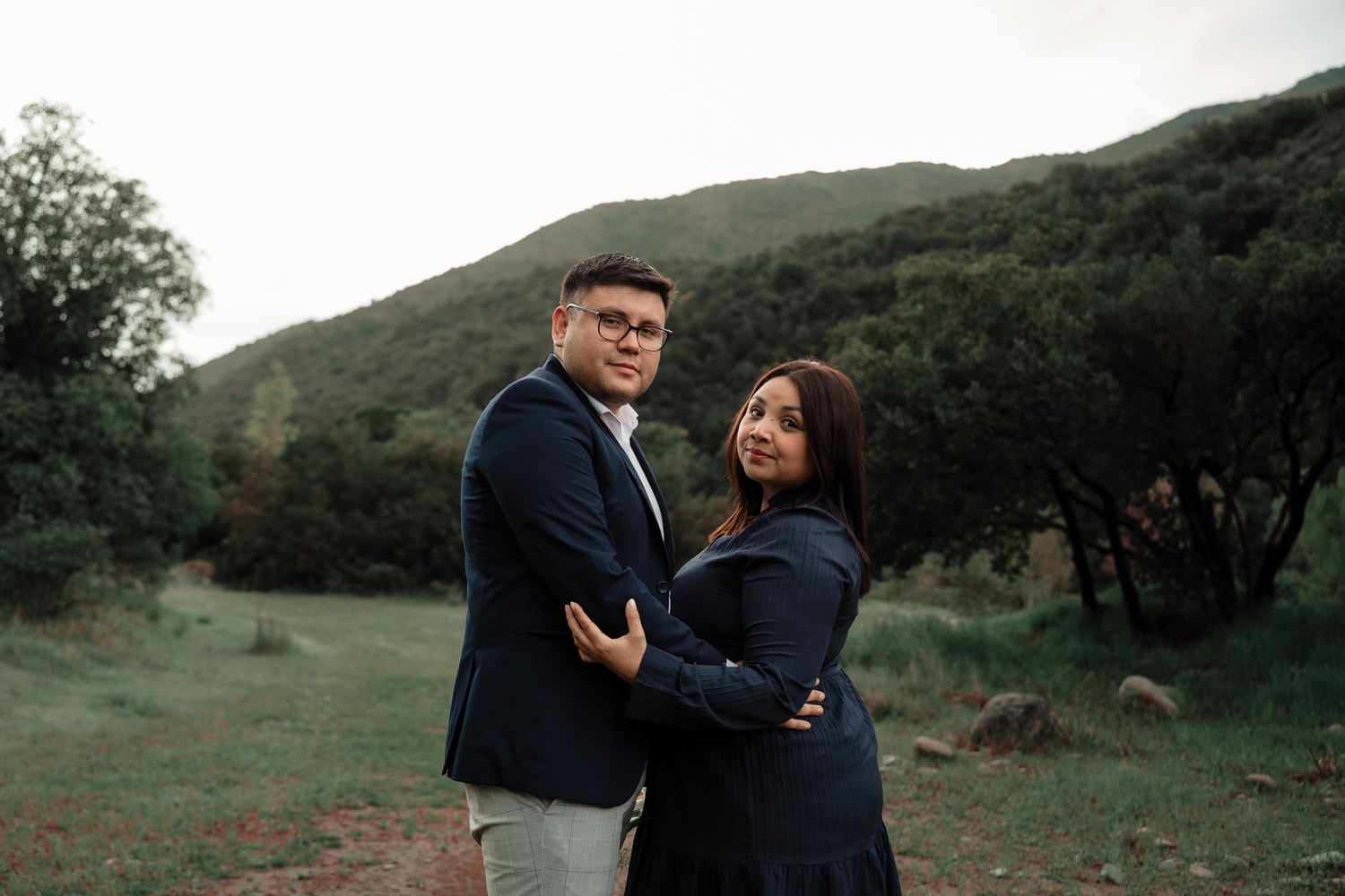 La pareja abrazada frente a los cerros